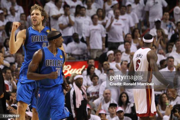 Dirk Nowitzki of the Dallas Mavericks reacts behind teammate Jason Terry after Nowitzki makes a jump shot in the fourth quarter while taking on the...