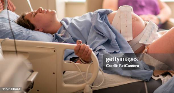 young woman in childbirth - muscular contraction stock pictures, royalty-free photos & images