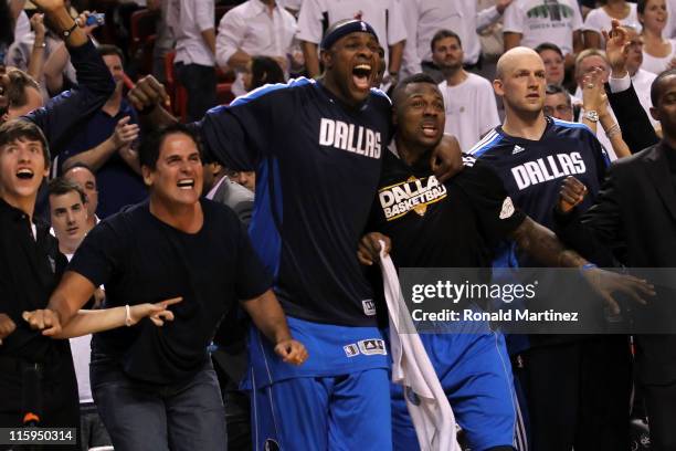 Owner Mark Cuban, Brendan Haywood and DeShawn Stevenson of the Dallas Mavericks react on the bench late in the fourth quarter while taking on the...