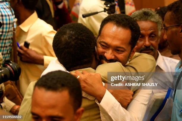 Protest leaders celebrate after the signing of the constitutional declaration with Sudan's army rulers, at a ceremony attended by African Union and...