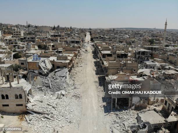 An aerial view taken on August 3 shows destroyed buildings in the town of Khan Sheikhun in the southern countryside of Idlib. The Syrian government...