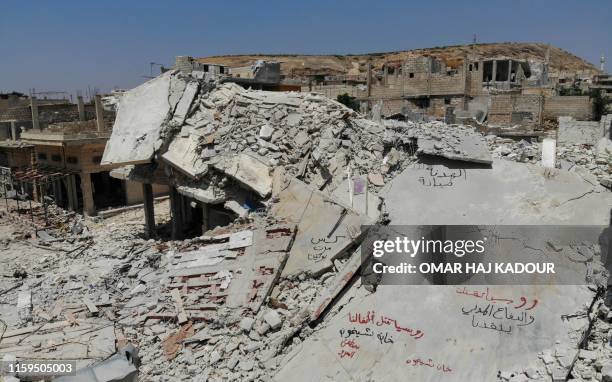 An aerial view taken on August 3 shows destroyed buildings in the town of Khan Sheikhun in the southern countryside of Idlib. - The Syrian government...