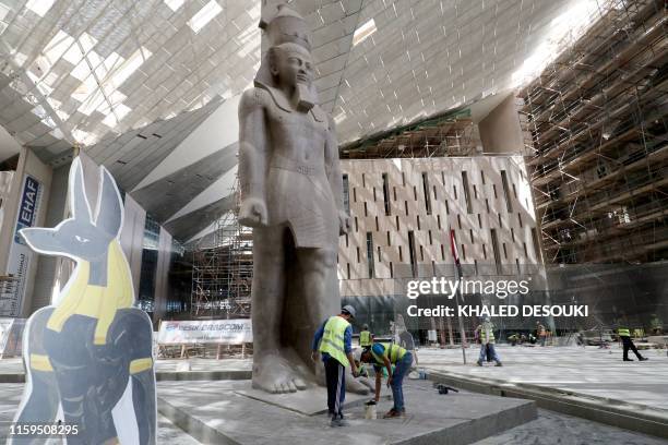 This picture taken on August 4, 2019 shows the 3,200-year-old pink-granite colossal statue of King Ramses II at the entrance of the Grand Egyptian...