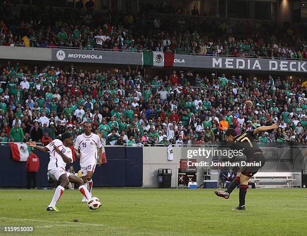 Pablo Barrera of Mexico fires a shot for a goal past Dennis Marshall of Costa Rica during a CONCACAF Gold Cup 2011 match at Soldier Field on June 12,...