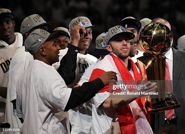 Jose Juan Barea of the Dallas Mavericks celebrates with the Larry O'Brien trophy after the Mavericks won 105-95 against the Miami Heat in Game Six of...