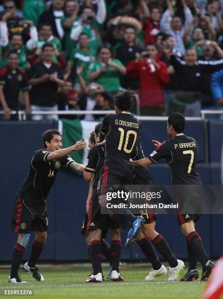 Members of Mexico including Efrain Juarez, Giovani Dos Santos and Pablo Barrera celebrate a goal against Costa Rica during a CONCACAF Gold Cup 2011...