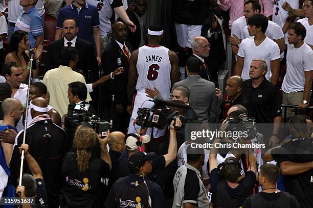 LeBron James of the Miami Heat walks off the court after the Dallas Mavericks won 105-95 in Game Six of the 2011 NBA Finals at American Airlines...