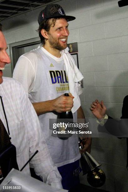 Dirk Nowitzki of the Dallas Mavericks walks through the halls of the arena with the Bill Russell Finals MVP trophy after the Maveircks won 105-95...