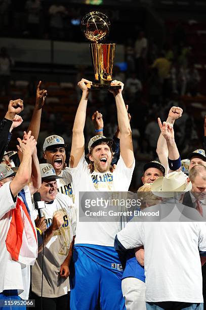 Dirk Nowitzki of the Dallas Mavericks lifts the Larry O'Brien Trophy in celebration after defeating the Miami Heat in Game Six of the 2011 NBA Finals...