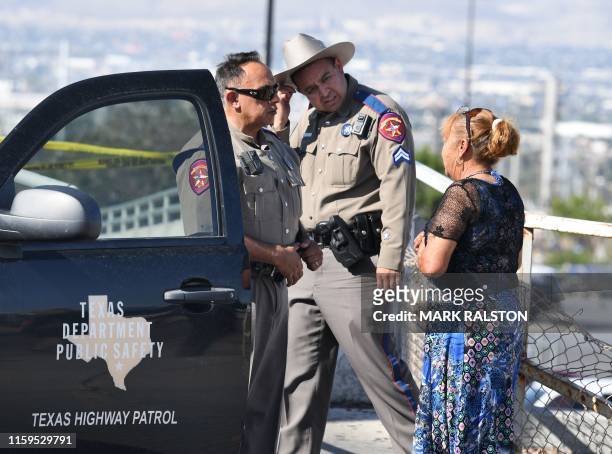 Virginia Chacon reacts as she tells her survival story to a police officer outside the Cielo Vista Mall Wal-Mart where a shooting left 20 people dead...