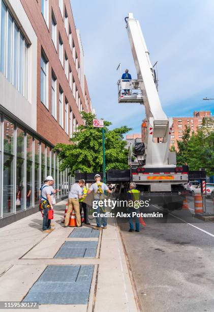 the construction team preparing for the high-altitude job. harlem, new york city - roof replacement stock pictures, royalty-free photos & images