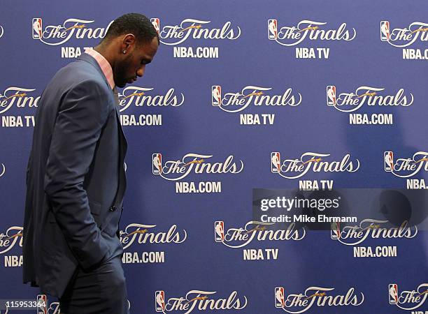 LeBron James of the Miami Heat walks into the interview room to answer questions after the Heat were defeated 105-95 by the Dallas Mavericks in Game...