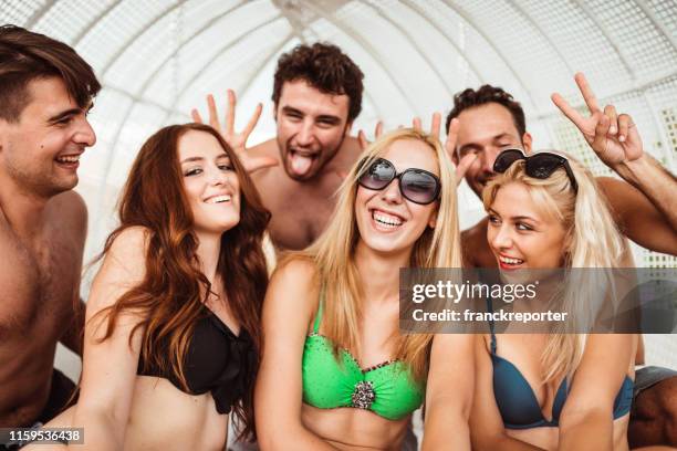 friends all together embraced on summer - slovenia beach stock pictures, royalty-free photos & images