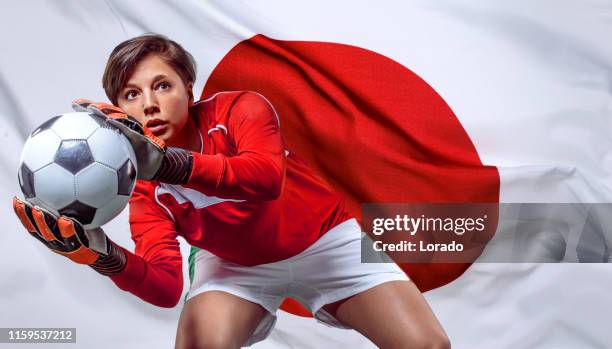 female soccer player with football and japanese flag - woman goalie stock pictures, royalty-free photos & images