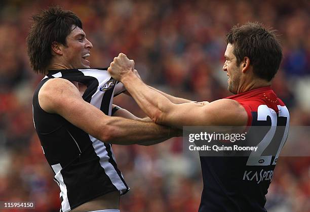 Leigh Brown of the Magpies wrestles with Jared Rivers of the Demons during the round 12 AFL match between the Melbourne Demons and the Collingwood...
