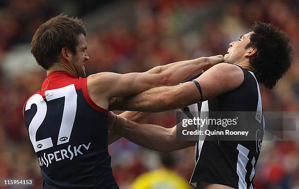 Leigh Brown of the Magpies wrestles with Jared Rivers of the Demons during the round 12 AFL match between the Melbourne Demons and the Collingwood...