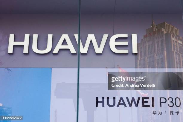 The Chinese national flag and a building are reflected in the shop window of a Huawei store on July 1, 2019 in Dongdaqiao, Chaoyang District,...
