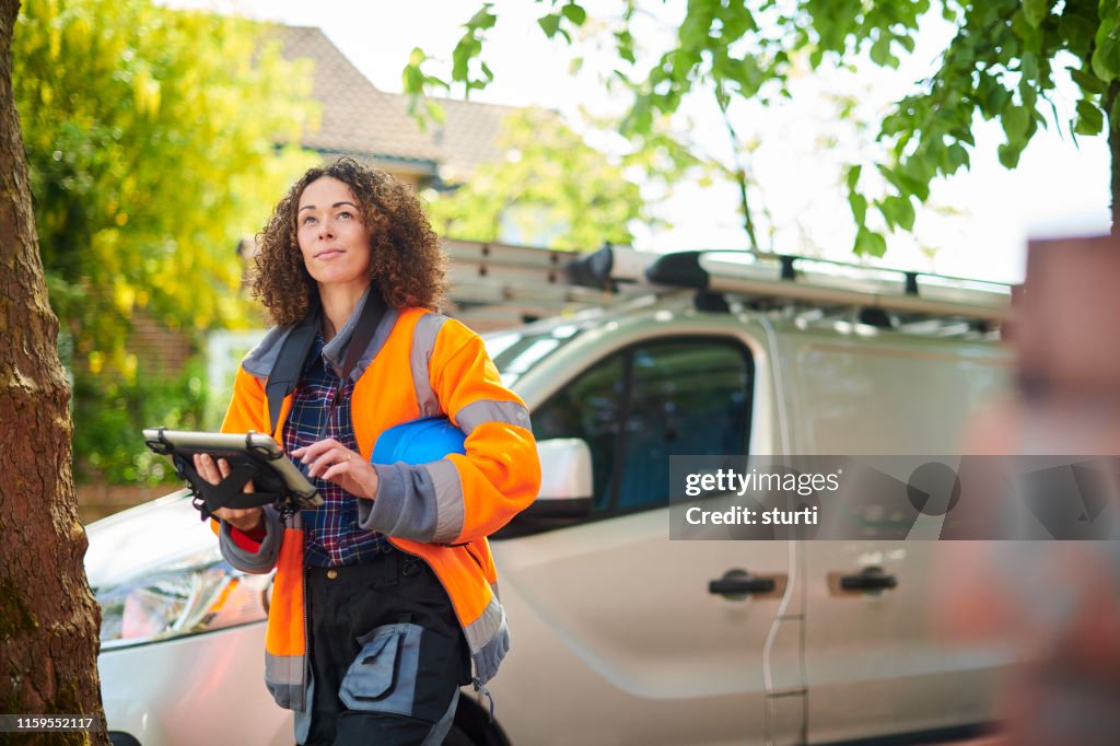 Female heating engineer arrives at job