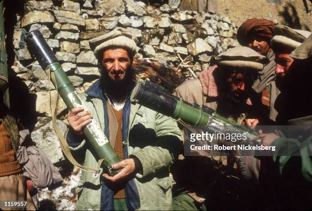 Guerrilla soldiers or mujahadeen stand with artillery at a remote base in the Safed Koh Mountains February 10, 1988 in Afghanistan. The end of Soviet...