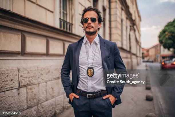handsome detective on the city street - detective stock pictures, royalty-free photos & images