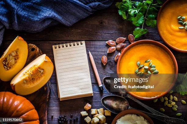 pumpkin soup with ingredients on rustic wooden table - cookbook stock pictures, royalty-free photos & images