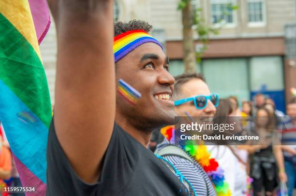 gay couple marching during pride parade - brazil body paint stock pictures, royalty-free photos & images