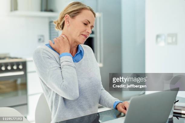 she carries a lot of stress in her back - neck pain stock pictures, royalty-free photos & images
