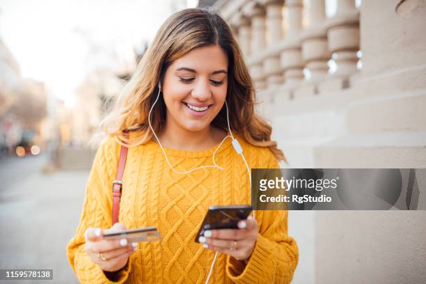 young woman buying on the internet - media buying stock pictures, royalty-free photos & images
