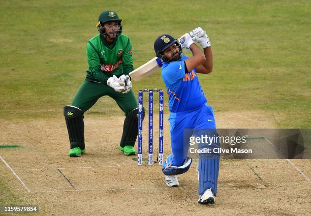 Rohit Sharma of India in action batting as Mushfiqur Rahim of Bangladesh looks on during the Group Stage match of the ICC Cricket World Cup 2019...