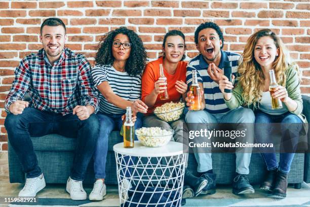 group of friends watching a football match on tv - drinking buddies filme imagens e fotografias de stock