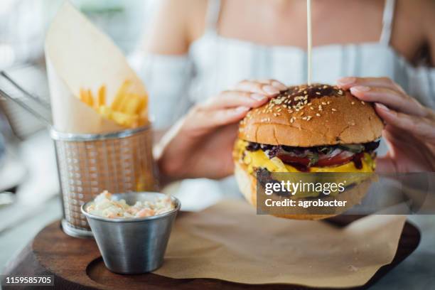 woman eating beef burger - child eating juicy stock pictures, royalty-free photos & images