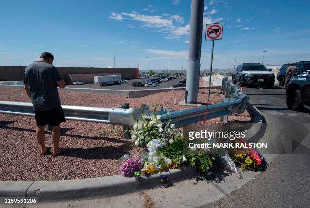 Alfredo Angcana prays beside a makeshift memorial outside the Cielo Vista Mall Wal-Mart where a shooting left 20 people dead in El Paso, Texas, on...