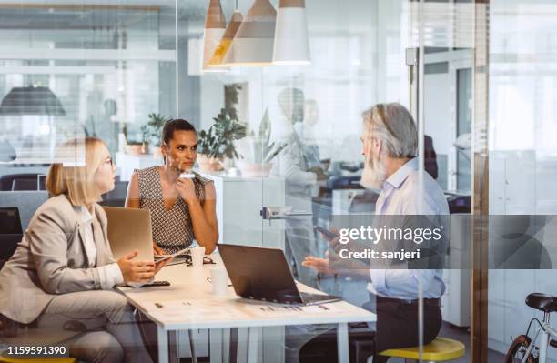 business people sitting at desk, discussing - life decisions stock pictures, royalty-free photos & images