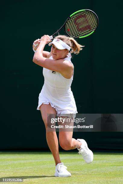 Kateryna Kozlova of Ukraine plays a backhand in her Ladies' Singles first round match against Lauren Davis of The United States during Day two of The...