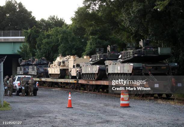 Two M1A1 Abrams tanks and other military vehicles sit on guarded rail cars at a railyard on July 2, 2019 in Washington, DC. President Trump asked the...