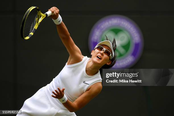 Saisai Zheng of China serves in her Ladies' Singles first round match against Ashleigh Barty of Australia during Day two of The Championships -...