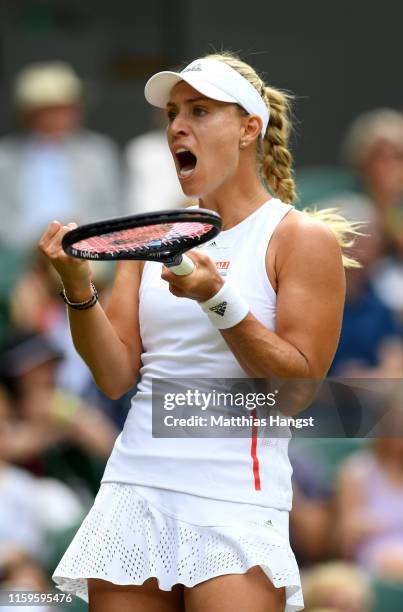 Angelique Kerber of Germany celebrates winning the first set in her Ladies' Singles first round match against Tatjana Maria of Germany during Day two...