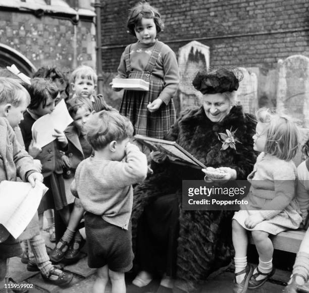 Italian educator Maria Montessori with young children at her school in Smithfield, London, circa 1951. .