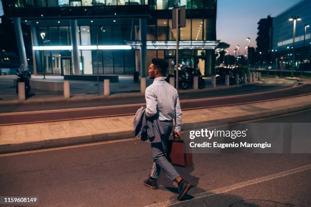 businessman crossing road, milano, lombardia, italy - evening walk stock pictures, royalty-free photos & images