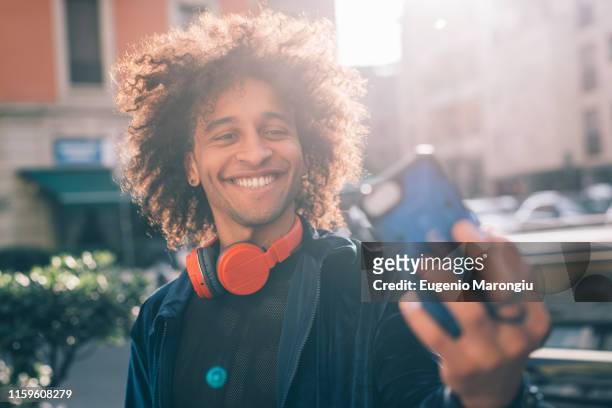 young man taking selfie in city, milano, lombardia, italy - selfie milan fotografías e imágenes de stock