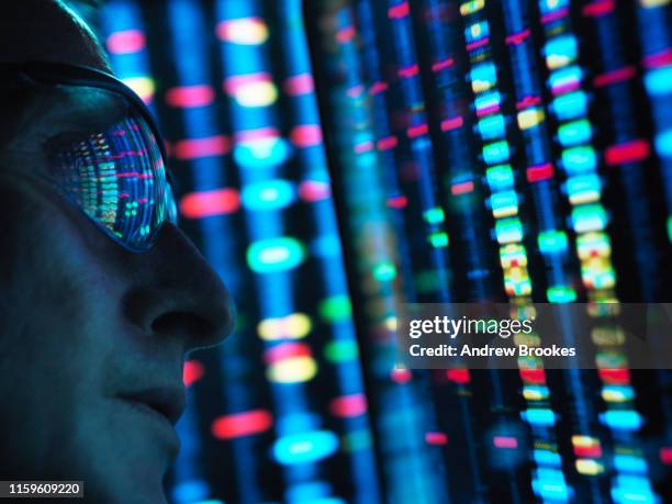 genetic research, scientist viewing dna information on screens, close up - technology discovery stock pictures, royalty-free photos & images