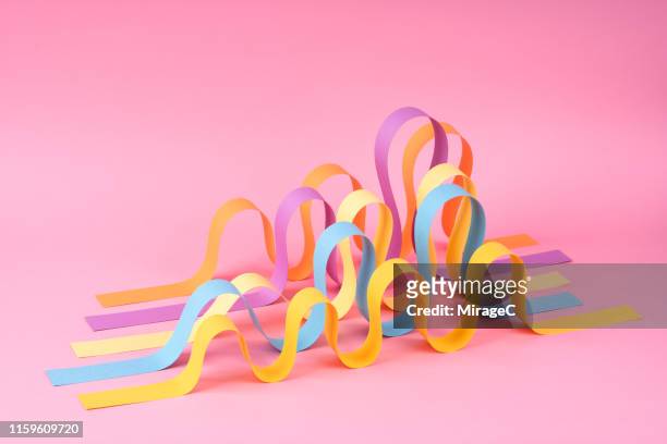 wave shaped paper stripes - sinus stockfoto's en -beelden