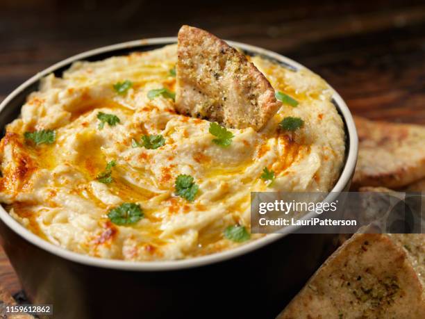 roasted garlic hummus with pita chips - tahini stock pictures, royalty-free photos & images