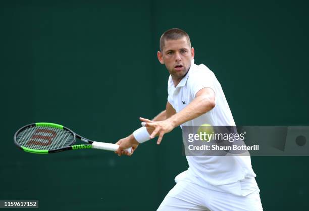 Filip Krajinovic of Serbia plays a forehand in his Men's Singles first round match against Dominik Koepfer of Germany during Day two of The...