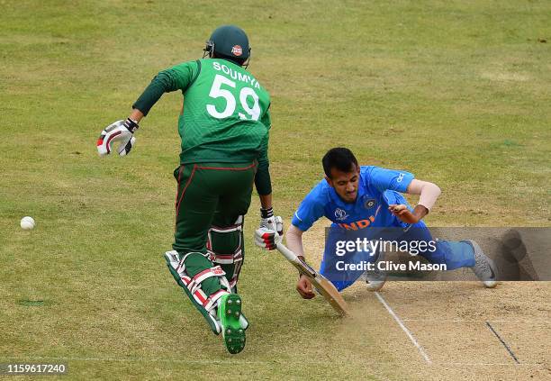 Yuzvendra Chahal of India is hit in the face by the bat of Soumya Sarkar of Bangladesh during the Group Stage match of the ICC Cricket World Cup 2019...