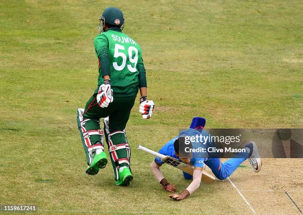 Yuzvendra Chahal of India is hit in the face by the bat of Soumya Sarkar of Bangladesh during the Group Stage match of the ICC Cricket World Cup 2019...