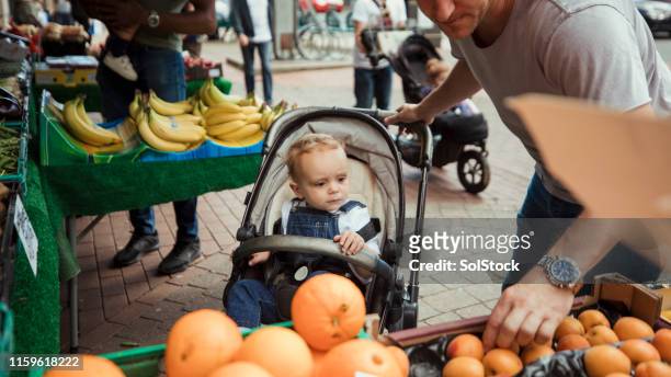 father and son shopping together - baby stroller imagens e fotografias de stock