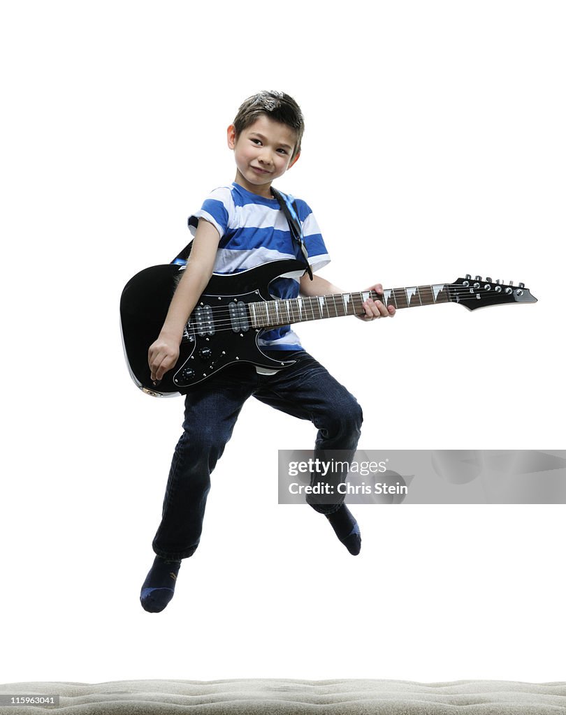 Half Asian Boy rocking out on an electric guitar