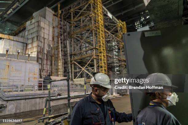 Workers inside the 'New Safe Confinement' which contains the old sarcophagus entombing the destroyed reactor number four at the Chernobyl Nuclear...