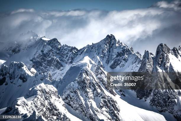 on the top of the swiss alps mountain range - snowy mountain peak stock pictures, royalty-free photos & images